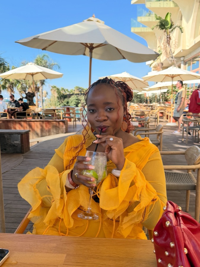 Me in a yellow dress at an outdoor café